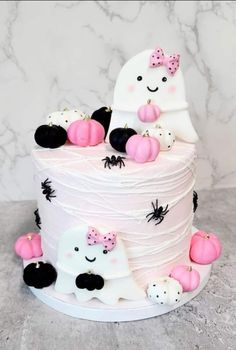 a white cake with pink and black decorations