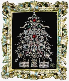 an ornate gold frame with a christmas tree in the center and ornaments around it, on a black background