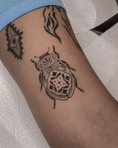 a lady bug tattoo on the left arm