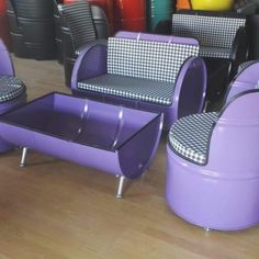 purple chairs and tables in a room with colorful vases