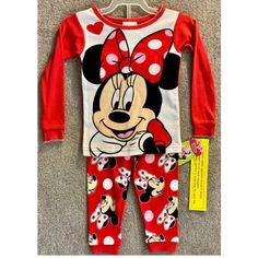 Get Your Little Girl Ready For Bed With This Adorable 2-Piece Pajama Set Featuring Her Favorite Disney Character, Minnie Mouse. The Set Includes A Long Sleeve Top And Matching Pants, Both Adorned With Colorful Minnie Mouse Graphics. The Pajamas Are Made For Girls In Size 18 Months And Are Perfect For Keeping Your Little One Cozy And Comfortable Throughout The Night. These Pajamas Are A Great Addition To Your Little One's Sleepwear Collection And Are Sure To Bring A Smile To Their Face. The Set I Cute Red Bedtime Set, Cute Red Bedtime Sets, Cute Red Pajama Party Sets, Red Cartoon Print Cotton Sleepwear, Red Cotton Sleepwear With Cartoon Print, Playful Minnie Mouse Sleepwear For Sleepover, Cute Minnie Mouse Sleepwear, Cute Minnie Mouse Sleepwear For Bedtime, Cute Minnie Mouse Sleepwear For Pajama Party