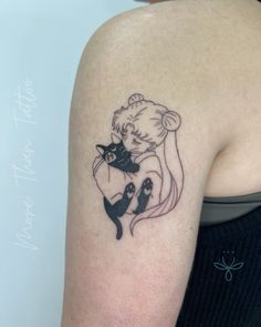 a woman with a cat tattoo on her arm