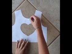 someone is making a heart out of paper