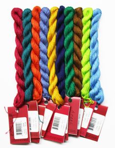 several skeins of multicolored yarn are shown in this image, with tags on them