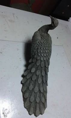 a statue of a bird on top of a table