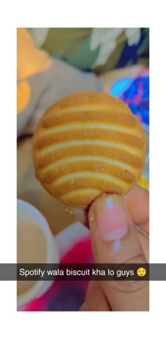 a person holding a cookie in their hand with the caption spotty waffle biscuit kha to guys