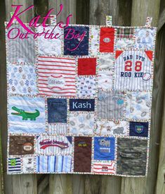 a quilt made to look like a baby's name on the side of a fence