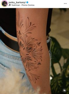 a person with a flower tattoo on their arm