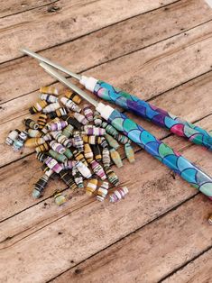 two umbrellas and some beads on a wooden table