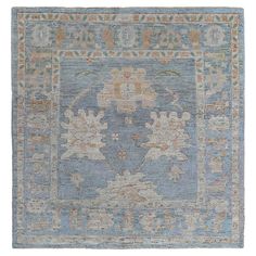 an antique rug with blue and beige colors