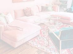 a living room filled with lots of furniture and decor on top of a wooden floor