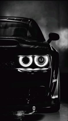 the front end of a black and white car