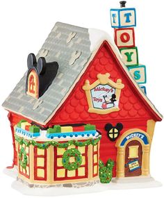 a small toy house with mickey mouse on the roof and letters that spell it's christmas