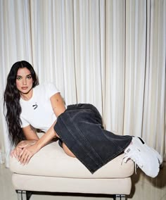 a woman sitting on top of a white couch