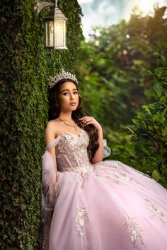 a woman in a princess dress leaning against a wall