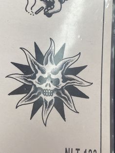 the back side of a sign with a skull and flower on it's face