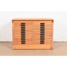 a wooden cabinet with black knobs on it