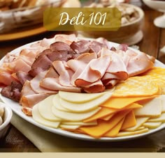 an assortment of meats and cheeses on a plate with the words deli 101