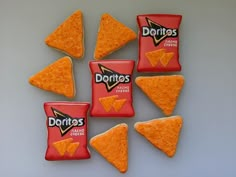 six cookies with chips in the shape of triangles and cheetos on them