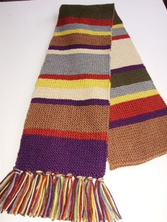 a multicolored scarf laying on top of a white table