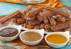 some churros and dipping sauces on a plate