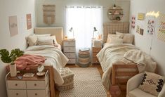 two twin beds in a small room with lots of pillows and blankets on top of them