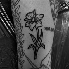 a black and white photo of a flower on the arm