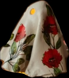 a white cloth with red flowers on it