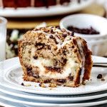 a slice of cinnamon swirl coffee cake sitting on top of plates next to a glass of milk