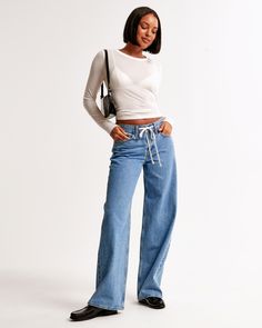 Our new classic ultra loose jeans in a medium wash, with drawstring waistband detail and a clean hem. This fit features an 8.5” low rise, is relaxed at the waist and hips and eases at the thigh into an ultra loose leg shape with a full-length inseam. We recommend buying your true size for a baggier fit. Size down for a closer fit. This jean is made from our lightweight rigid denim, a super soft authentic cotton fabric with no stretch. Women's Bottoms, Loose Jeans, Suits Coats, New Classic, New Arrival Dress, Drawstring Waistband, Baggy Fits, Swimwear Accessories, Abercrombie Fitch