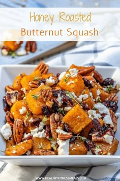 honey roasted butternut squash with goat cheese and pecans in a white serving dish