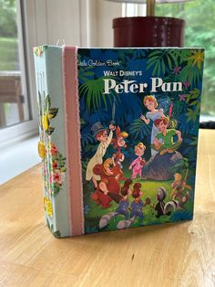 the walt and mickey's peter pan book is sitting on a table