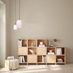 an empty room with a book shelf, lamp and other items on the floor in front of it