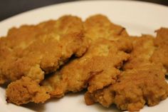 three pieces of fried food on a white plate