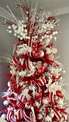 a red and white christmas tree decorated with ornaments