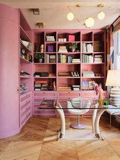 a living room filled with lots of pink furniture