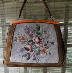 Beautiful petite point hand bag from 60's in good vintage condition 7/10 (in a few places the thread on the tapestry is missing) + color: brown leather + pattern: floral/tapestry + orange mother of pearl detail + metal buckle + light green lining dimensions 31 x 24cm handle 20 x 13cm Vintage Beige Satchel, Vintage Embroidered Tapestry Shoulder Bag, Vintage Beige Embroidered Shoulder Bag, Vintage Handmade Tapestry Bag, Vintage Tapestry Handmade Bags, Vintage Beige Tapestry Bag, Handmade Vintage Brown Bag, Vintage Tapestry Travel Bag, Vintage Beige Satchel With Handles