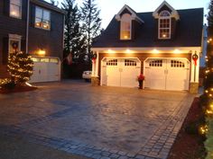 two garages with christmas lights on the driveway