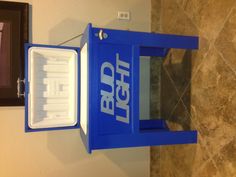 an ice chest with the bud light logo on it sits in front of a painting