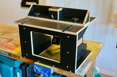 a large metal box sitting on top of a wooden workbench in a garage