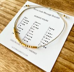 a bracelet that is sitting on top of a piece of paper with words written in it