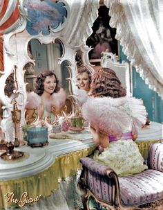 an old fashion photo of two women in front of a mirror with cake on it