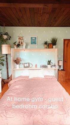 a bed with pink sheets and pillows in a bedroom