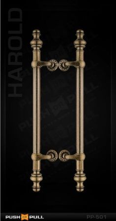 an antique brass door handle on a black background with the words harrold above it