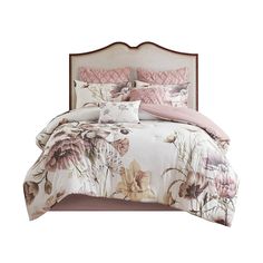 a bed with floral comforter and pillows on it's headboard, against a white background