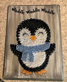 a penguin with a blue scarf on it's head and the words waddle waddle