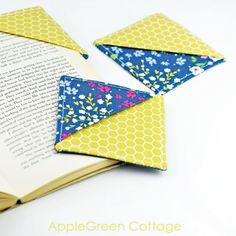 an open book with two folded envelopes on top of it and the title applegreen cottage