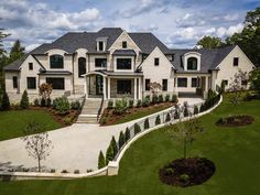 an aerial view of a large home with landscaping