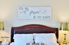 a bed with two lamps on either side and a sign above it that says you will forever be my always