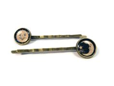 A pair of hair pins, with an image of the sun and moon symbols from the corners of a Ouija board under a clear setting, in a 12mm brass bezel. Packaged on a metallic damask card, with the settings positioned as you see in the first picture, so that you can wear them on opposite sides of your head to mimic a Ouija board. If you would like them facing the same way as in the model photos, please let me know in the Notes to Seller section at checkout.  Perfect for any lover of Tarot, oracle, Ouija, Moon Symbols, Occult Symbols, Ouija Board, Head Accessories, Diy Costumes, Sun Moon, Baby Bag, Cute Jewelry, Things To Buy